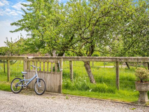 a blue bike parked next to a fence at Whitehill Lodge - Uk47194 in Kirkcambeck