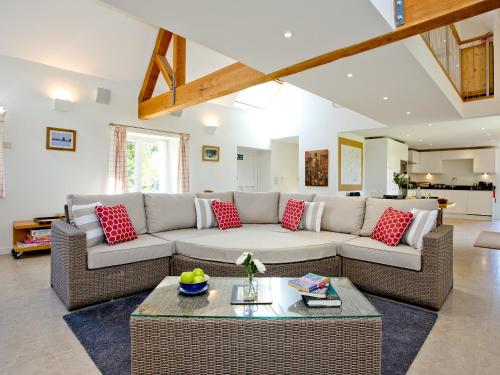 a living room with a couch and a table at Antells Farm Barn in Sturminster Newton