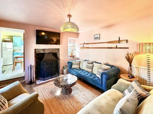 a living room with a blue couch and a fireplace at Coast Away in Fraserburgh