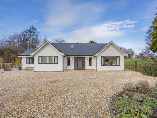 a large white house with a gravel driveway at Amaranth in Shurdington