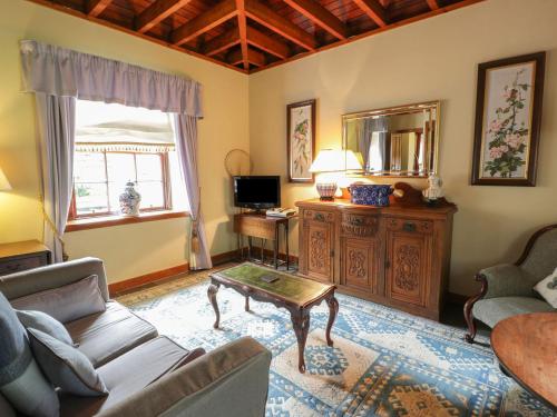 a living room with a couch and a coffee table at Duck Pond- Uk7232 in Kirkmichael