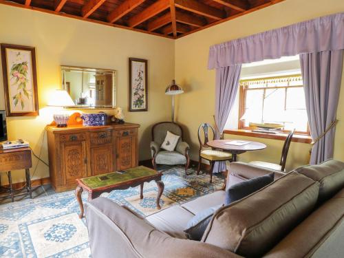 a living room with a couch and a table at Duck Pond- Uk7232 in Kirkmichael