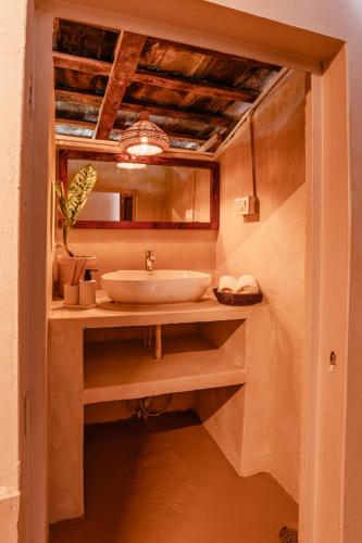a bathroom with a sink and a mirror at The Attic Library by AVVAs Stays in Bīr