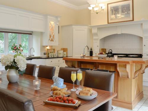 a kitchen with a wooden table with food on it at The Coach House in Keswick