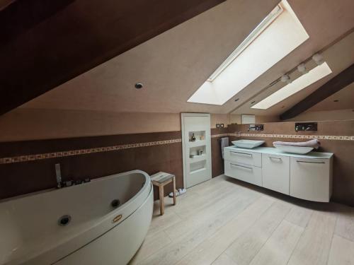 a large bathroom with a large tub and a sink at Villa Simona in Voghera