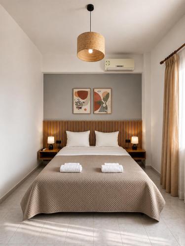 a bedroom with a large bed with two pillows at Harmonia Himara in Himare