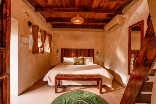 a bedroom with a bed and a wooden ceiling at The Attic Library by AVVAs Stays in Bīr