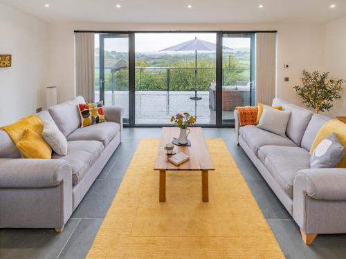 a living room with two couches and a coffee table at Cwtch Ty Gwyn in Llandeilo