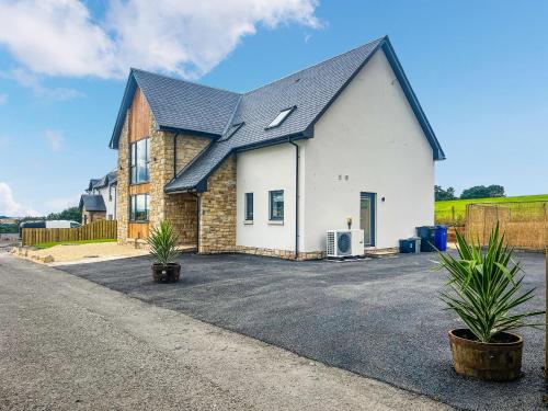 a large white house with a black roof at Hillside House in Berwick-Upon-Tweed