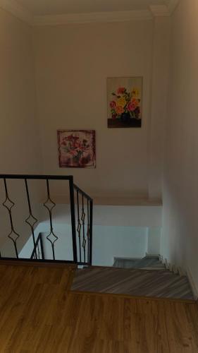 a staircase in a room with a painting on the wall at Daily airport aparthotel in Taşoluk