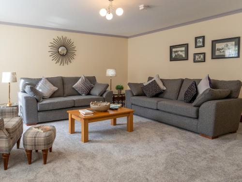 a living room with two couches and a coffee table at Sycamore Cottage-Uk2785 in Penmaen-mawr