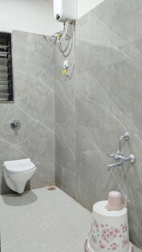a bathroom with a shower and a toilet in it at Vishal Lodge in Yermala