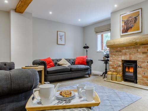 a living room with a couch and a fireplace at The Vintage Store - Uk32652 in Elston