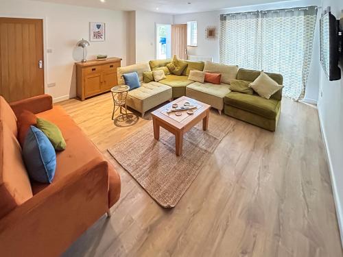 a living room with a couch and a table at No 3 Rabbit Warren-Uk44299 in Lenwade