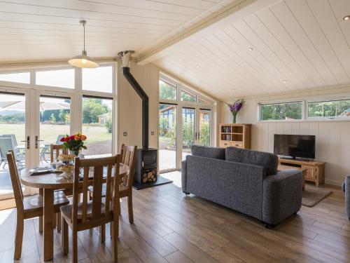 a living room with a couch and a table at Oak Lodge in Hassocks