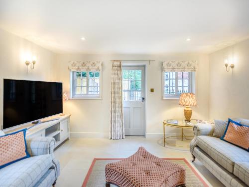 a living room with two couches and a flat screen tv at Halton Lodge in Halton Holegate