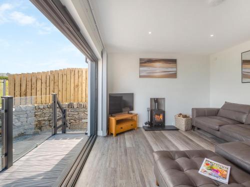 a living room with a couch and a tv at Goppa in Llanfair
