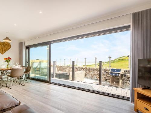 a living room with a large sliding glass door at Goppa in Llanfair
