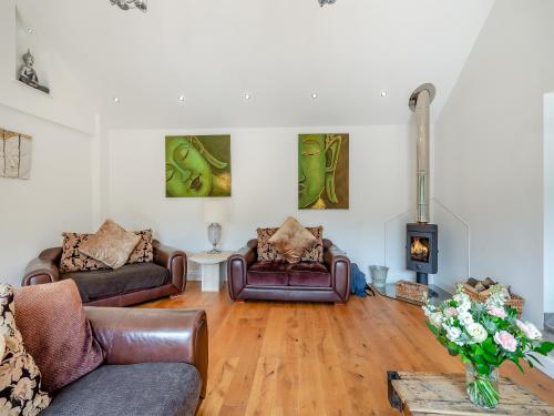 a living room with two couches and a fireplace at Foxton Lodge - Uk47296 in Harrietsham