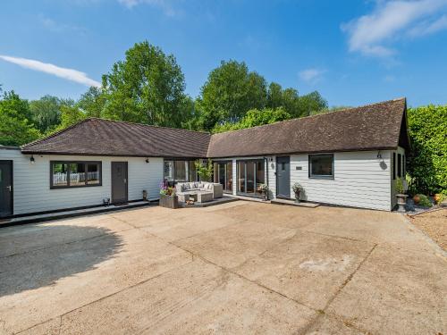 a house with a large driveway in front of it at Foxton Lodge - Uk47296 in Harrietsham