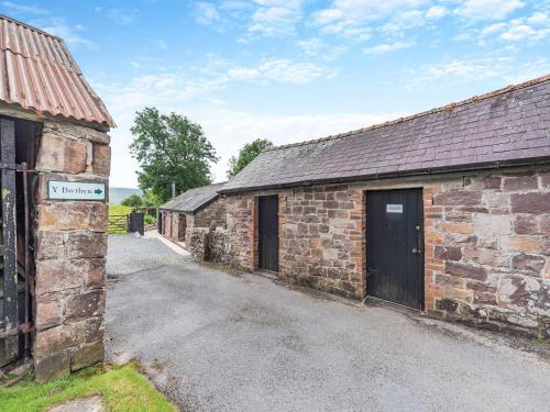 an external view of an old brick building at Y Bwthyn-Oxm in Gwynfe