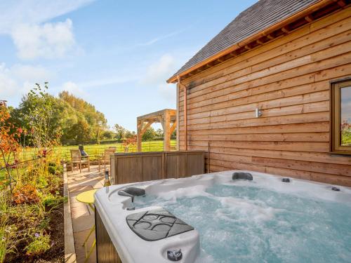a hot tub on the side of a building at Hare's Furrow - Uk12607 in Burton Overy