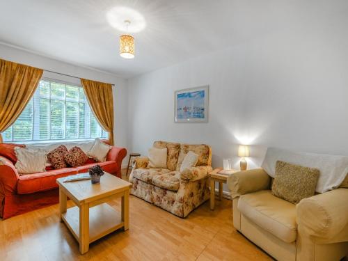 a living room with two couches and a table at Spruce Cottage - Uk46875 in Hartland
