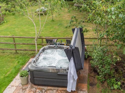 an umbrella sitting on top of a hot tub at Dower House Lodge in Ludlow