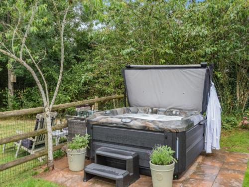 a black bath tub sitting next to two potted plants at Dower House Lodge in Ludlow