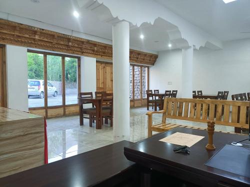 a room with a table and chairs and a dining room at Hotel Samyas in Khalatse