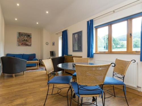 a living room with a table and chairs at Parkers Lodge in Mathon