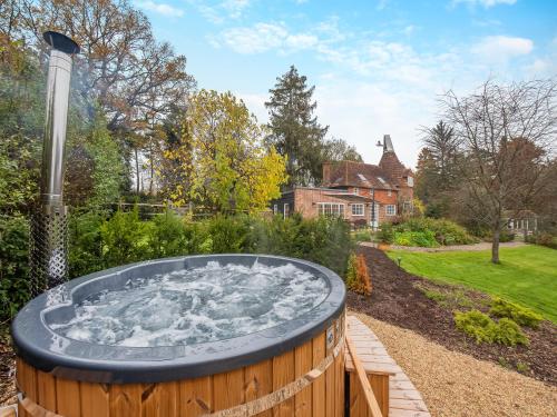 a hot tub in the garden of a house at Mousehall Oast in Wadhurst