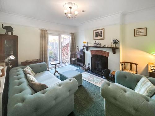 a living room with two couches and a fireplace at Hill View in Minehead