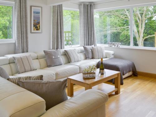 a living room with a couch and a table at Florina in Cheriton Bishop