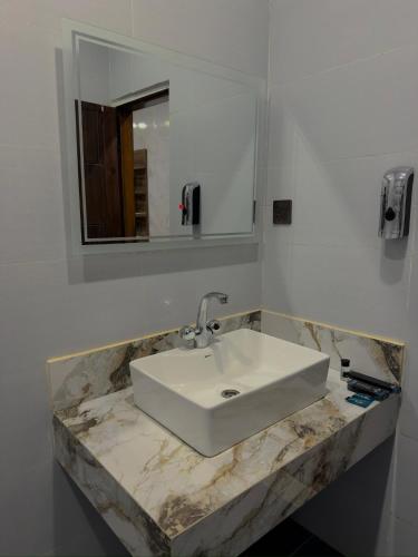 a bathroom with a white sink and a mirror at Go Glam Hotels Murree in Murree