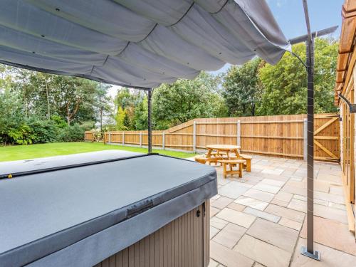 a patio with a pool table and a picnic table at Tawny Acre Barn - Uk38614 in Wisbech