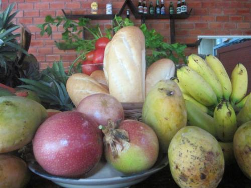 a pile of fruit and vegetables on a table at Gia Thanh Phu Quoc Guest House in Phu Quoc