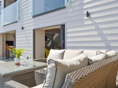 a couch sitting on a patio with a table at Tan Y Fford in Bangor