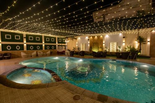a large swimming pool in a hotel with lights at Hotel Bobina in Gorakhpur