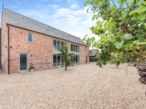 an exterior view of a brick building with a courtyard at Dragonfly Den - Uk44530 in Horncastle