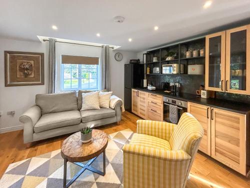 a living room with a couch and a table at Eagles Nest in Guildford