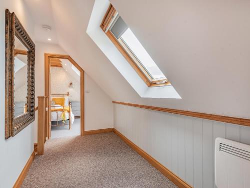 a hallway with a mirror and skylight in a house at Lucky's Stable - Uk34101 in Chichester