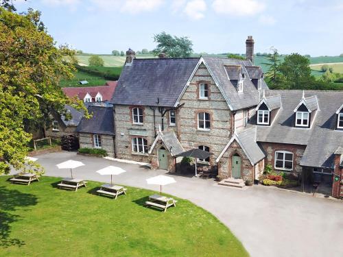 an aerial view of a large house with chairs and umbrellas at Rawlsbury Lodge - Uk31007 in Ansty