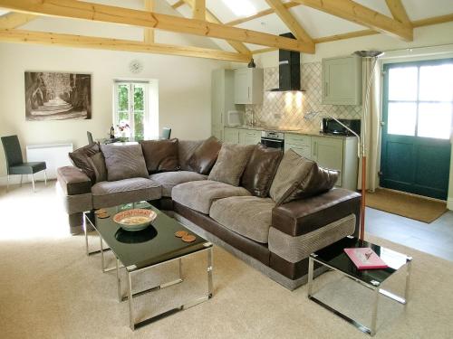 a living room with a couch and a table at The Barn in Carleen