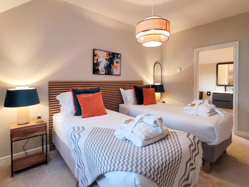 two beds in a room with two lamps at The Birches - Ukc4619 in Dunholme
