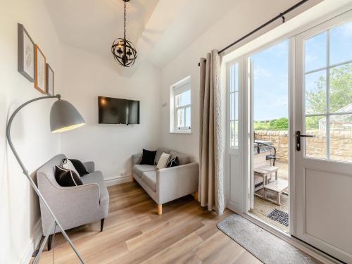 a living room with a door leading to a patio at Bolton Farm in Durham