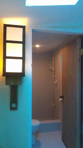 a bathroom with a toilet and a window at Gomez Guest House in Tagbilaran City