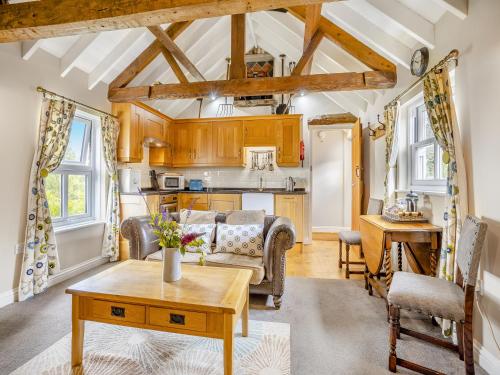 a living room with a couch and a table at The Hayloft - Uk47153 in Burgh le Marsh