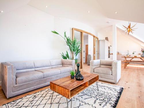 a living room with a couch and a coffee table at The Penthouse in Woolacombe