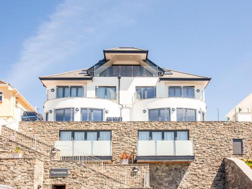 a white building on top of a stone wall at The Penthouse in Woolacombe